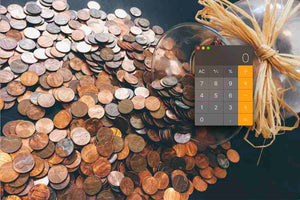 Image with pennies and a calculator. Calculate your music streaming royalties for popular music streaming platforms like spotify, deezer, apple music, pandora and more. 